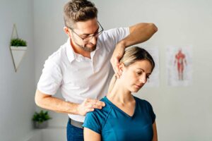 Pregnant woman doing a gentle back stretch on hands and knees beside a supportive pillow